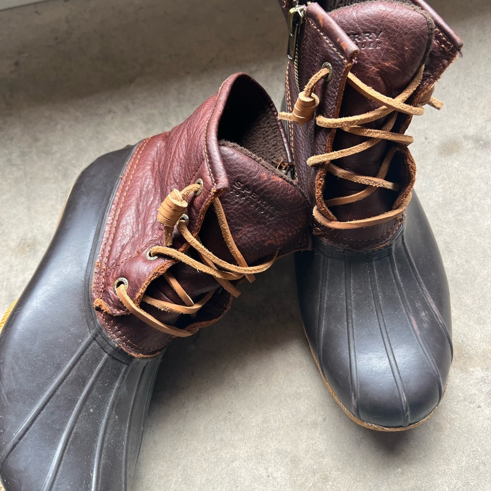 Brown and black sperry boots
